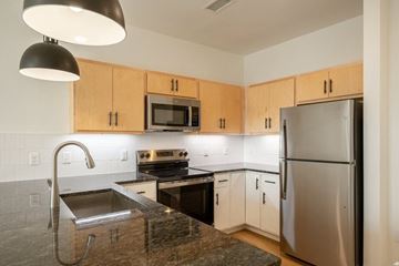 Richmond apartment for rent - A kitchen with a stainless steel refrigerator and a granite countertop.