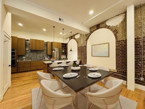 Richmond apartment for rent - A dining room with a black table and white chairs.