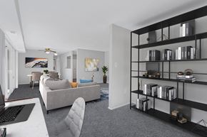 Washington apartment for rent - an open living room with a couch and a desk with a laptop