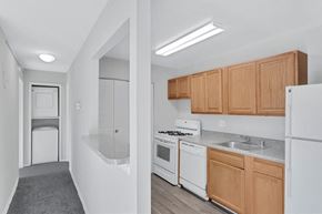 Washington apartment for rent - a kitchen with white appliances and wooden cabinets