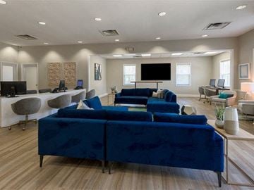 Waldorf townhouse for rent - a large living room with blue couches and a television