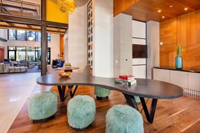 Fairfax apartment for rent - A modern dining room with a round table and blue pouf.