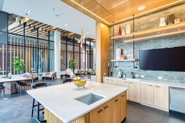 Richmond apartment for rent - a kitchen and living room with a tv and a table with chairs