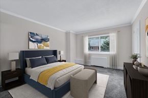 Bethesda apartment for rent - A bedroom with a large bed and a painting on the wall.