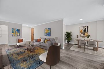 Bethesda apartment for rent - A living room with a brown chair and a blue rug.