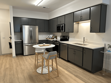 Richmond apartment for rent - A kitchen with a table and chairs in the middle of it.