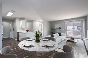 Lexington Park apartment for rent - A modern dining room with a round marble table and grey chairs.