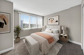 Bladensburg apartment for rent - A bedroom with a bed, nightstand, and window.