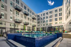 Richmond apartment for rent - a large pool in front of a large apartment building