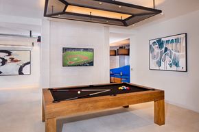 Fairfax apartment for rent - A pool table in a room with a painting of a baseball field on the wall.