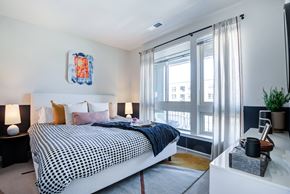 Alexandria apartment for rent - A bedroom with a large bed and a window with curtains.