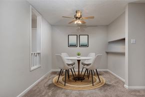 Richmond apartment for rent - a dining room with a table and chairs and a ceiling fan