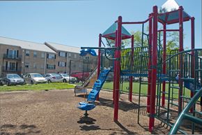 Hyattsville apartment for rent - a playground with a slide in front of an apartment building
