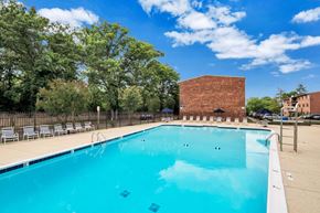 Alexandria apartment for rent - a swimming pool with a brick building in the background
