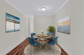 Alexandria apartment for rent - A dining room with a round table and blue chairs.