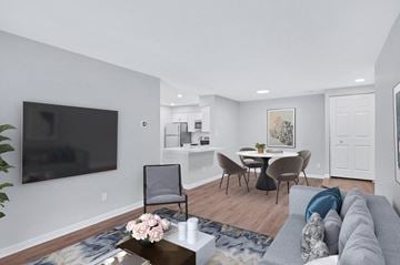 Reston apartment for rent - a living room with a couch and a table with chairs