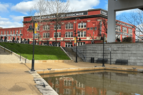 Richmond apartment for rent - a large red building with a pond in front of it