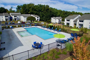Richmond apartment for rent - a swimming pool with chairs and umbrellas in front of apartment buildings