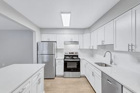 Columbia apartment for rent - a large white kitchen with white cabinets and stainless steel appliances
