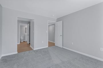 Columbia apartment for rent - a living room with a carpet and a door to a bathroom