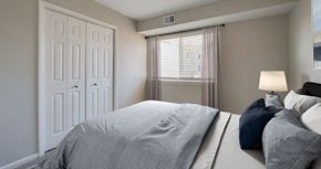 Newport News apartment for rent - A bedroom with a large bed and a window with curtains.