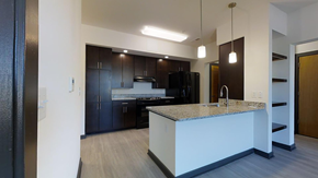 Charlottesville apartment for rent - a kitchen with a large island and dark wood cabinets