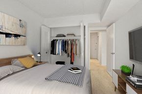 Reston apartment for rent - a bedroom with a bed and a closet with clothes