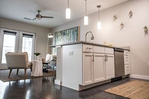 Richmond apartment for rent - an open living room and kitchen with a counter top and a refrigerator