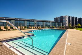 Richmond apartment for rent - a swimming pool with a building in the background