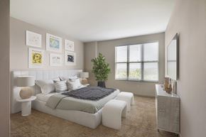 Washington apartment for rent - a white bedroom with a bed and a mirror