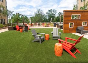 Washington apartment for rent - a lounge area with chairs and a fire pit on a lawn