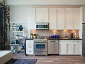 Washington apartment for rent - a white kitchen with stainless steel appliances and white cabinets