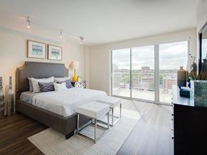 Washington apartment for rent - a bedroom with a bed and a large window