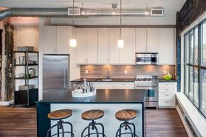 Washington apartment for rent - a bar with wooden stools and white walls and a stainless steel railing