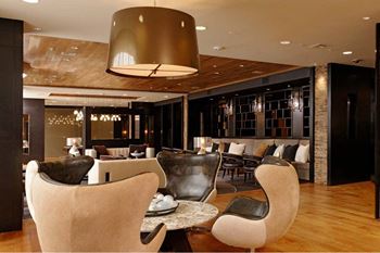 The lounge - spacious gathering room with luxe furnishings surrounding a cozy fireplace