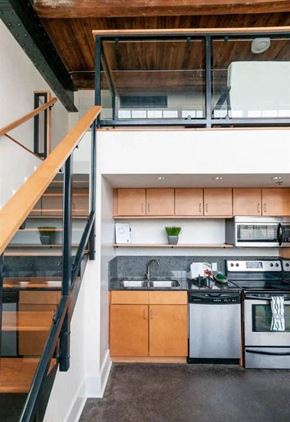 Richmond apartment for rent - a kitchen with a stainless steel stove and a staircase