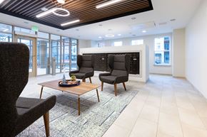 Baltimore apartment for rent - A modern office space with a wooden table and black chairs.