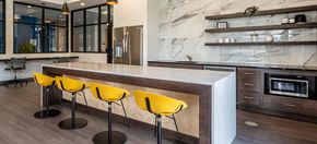 Memphis apartment for rent - a kitchen with a large counter and yellow chairs