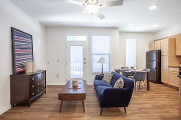 Louisville apartment for rent - A living room with a blue couch and a wooden coffee table.