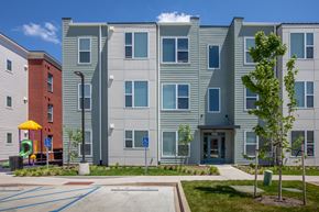 Louisville apartment for rent - Parking lot, playground, and landscaping in front of apartment buildings-Beecher Terrace, Louisville, KY