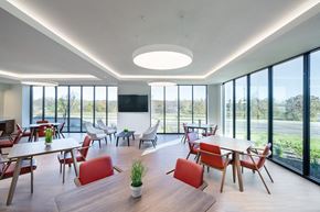 Fort Worth apartment for rent - A modern dining room with red chairs and a wooden table.