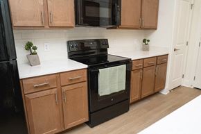 Fort Worth apartment for rent - A black oven with a white towel hanging in it.