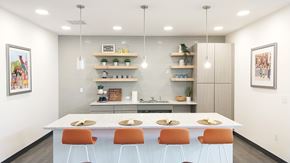 Memphis townhouse for rent - A modern kitchen with a white table and orange chairs.