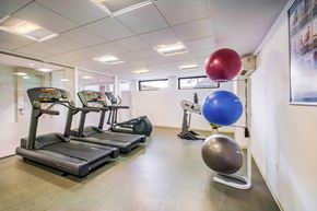 Washington apartment for rent - A gym with treadmills, exercise balls, and a mirror.
