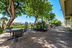 Los Angeles apartment for rent - A patio with a table and chairs surrounded by trees.