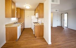 Los Angeles apartment for rent - A kitchen with wooden cabinets and a white fridge.