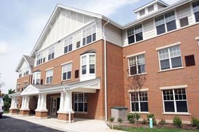 St. Louis apartment for rent - a brick apartment building with white columns and a porch