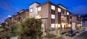 Los Angeles apartment for rent - Rio Vista Apartment building at night with lush foliage and greenery along the sidewalks