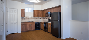 Los Angeles apartment for rent - an empty kitchen with black appliances and wood flooring