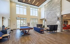 Baltimore apartment for rent - Community room at Perkins Square Apartments with pool table and lounge seating areas